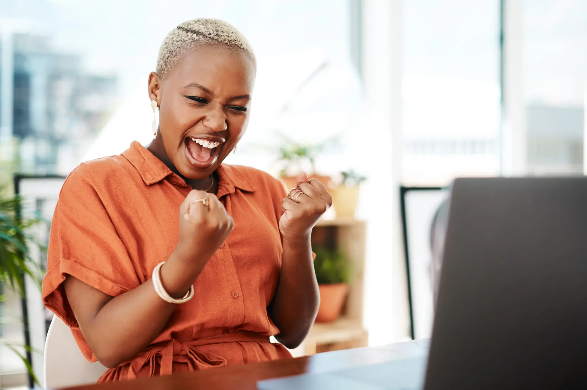 Business, fist and black woman with success, celebration and achievement in a workplace. Female employee, person and entrepreneur with happiness, startup and cheering with good news, email and goals.